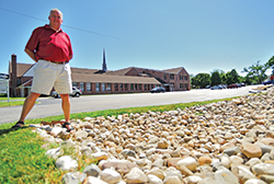 Lou Etgen of the Alliance for the Chesapeake Bay checks the solution he helped set up for St. Luke's Lutheran Church. Photograph, Michael W. Fincham